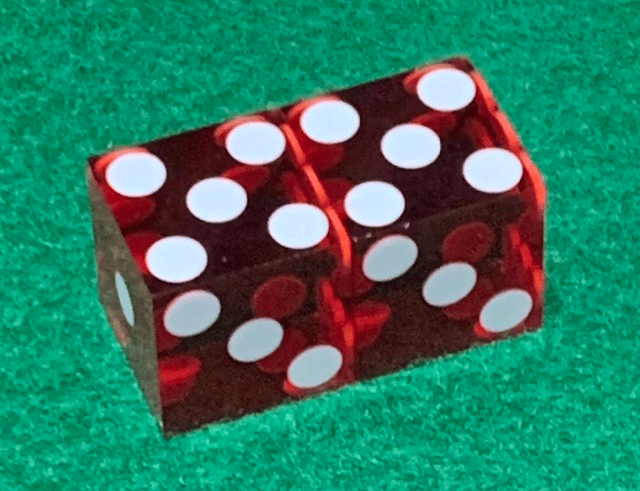 Dice with 5's on top and 3's showing on the face.