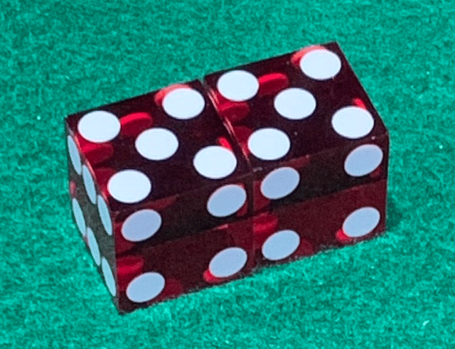 Dice with 5's on top and 4's showing on the face.