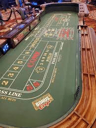 A crapless craps table with a pass line bet and dice